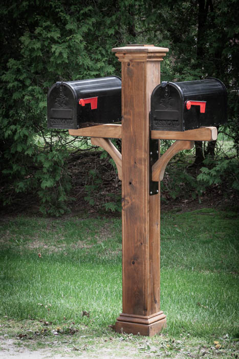double cedar mailbox post with two black mailboxes, cedar post cap, and two steel brackets