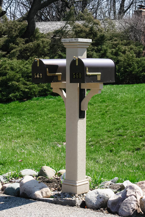 double mailbox post post with a white granite post cap, black mailbox brackets and a Textured finish